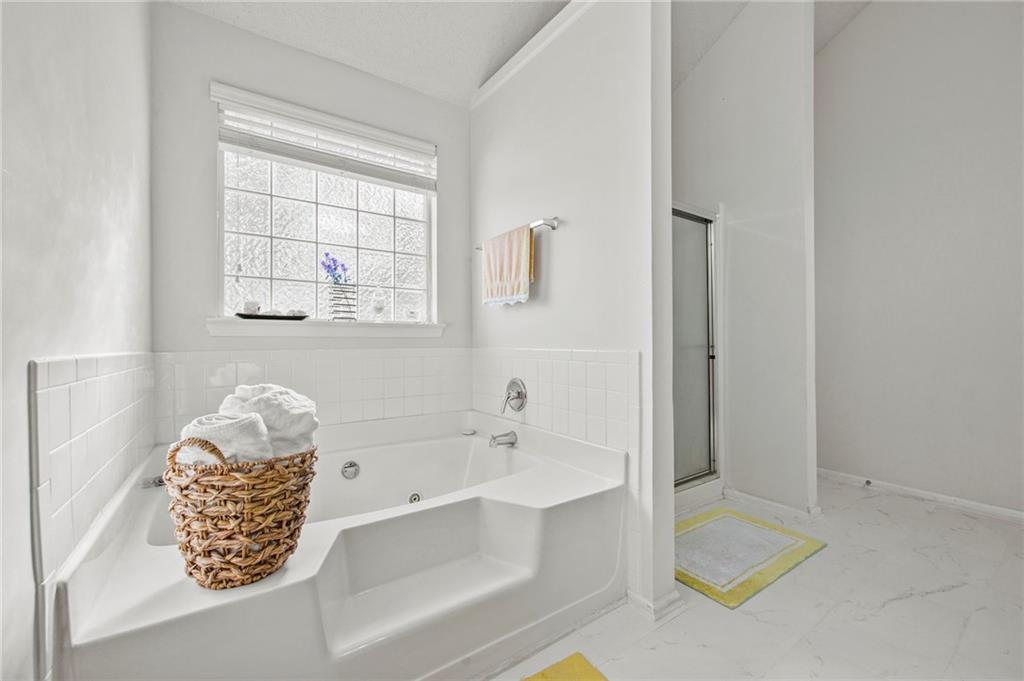 407 Grier Drive Locust Grove, GA 30248 - Photo 28 of 38 a bathroom with a tub sink and mirror
