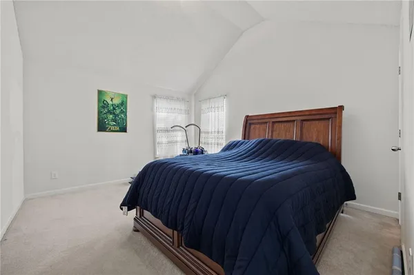 a bedroom with bed and a window