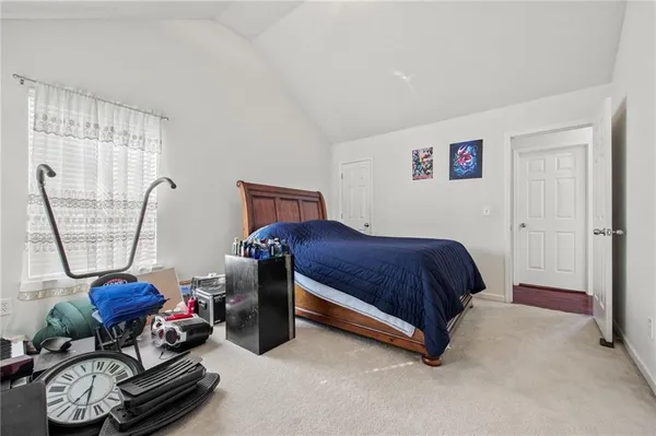 a bathroom with a sink toilet double vanity and shower