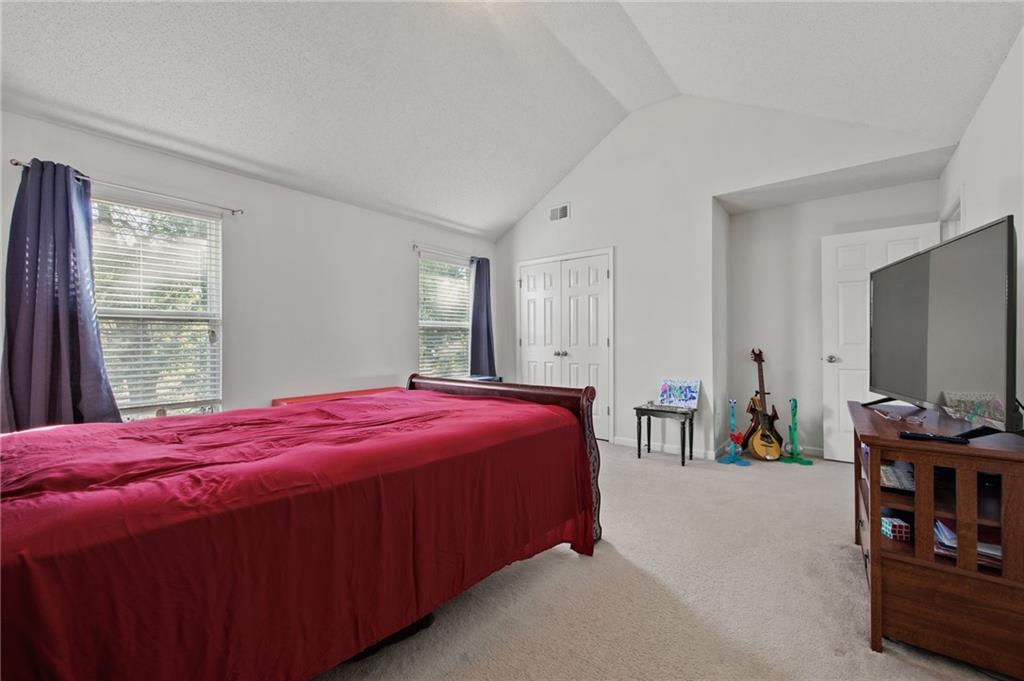 407 Grier Drive Locust Grove, GA 30248 - Photo 34 of 38 a bedroom with a bed and a large window