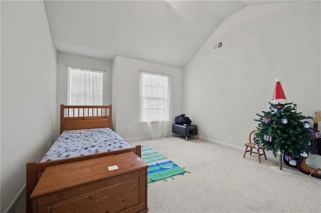 a bedroom with a bed and a potted plant