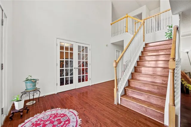 a view of entryway with wooden floor and stairs