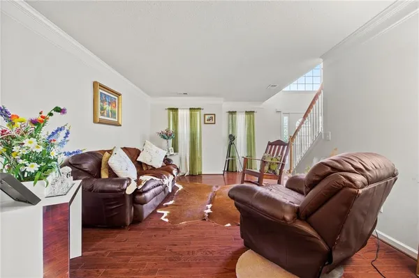a living room with furniture flowerpot and a potted plant