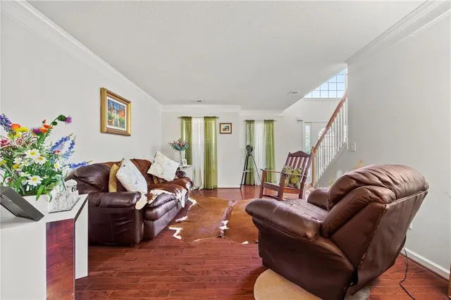 a living room with furniture flowerpot and a potted plant