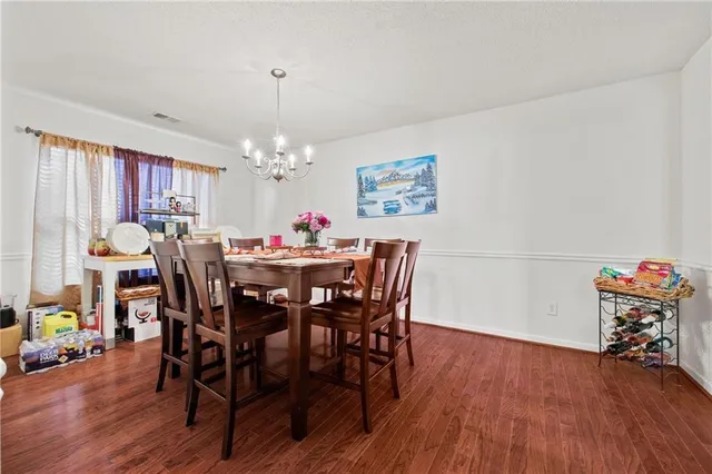 a dining room with furniture and wooden floor