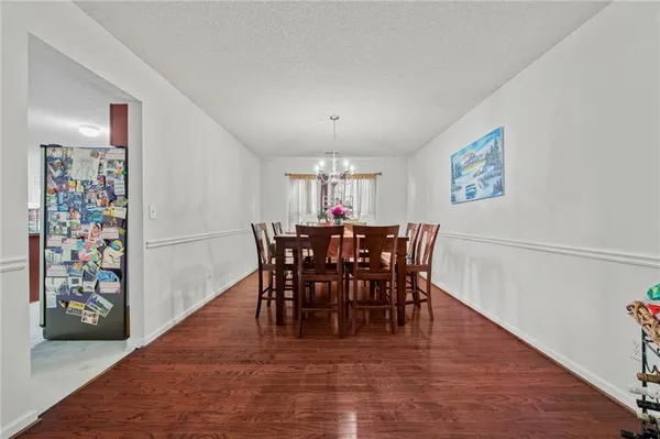 a view of a dining room with furniture and chandelier