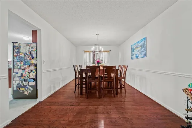 a view of a dining room with furniture and chandelier