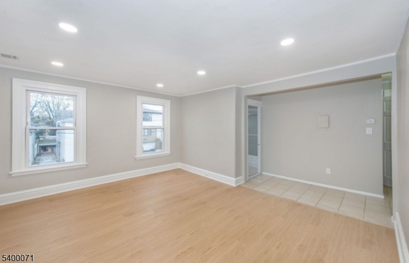 25 Henry Street, Unit 2 Bloomfield, NJ 07003 - Photo 4 of 7 an empty room with windows and closet