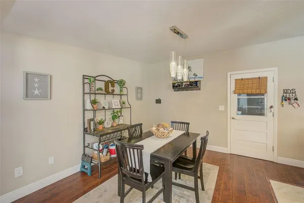 a view of a dining room with furniture and wooden floor