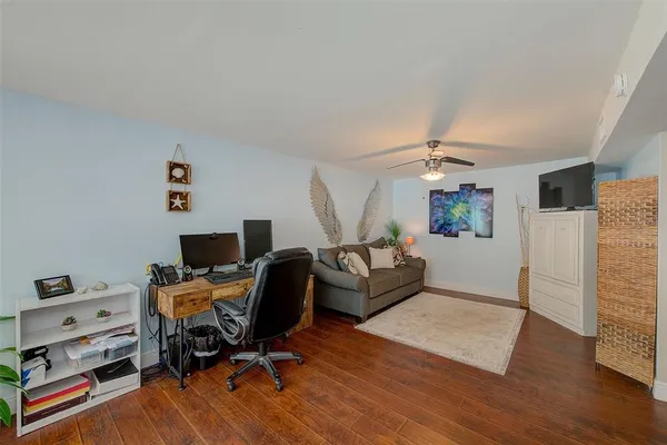 a livingroom with workspace and a couch