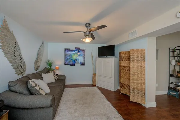 a living room with furniture and wooden floor
