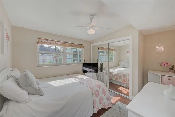 a bedroom with a bed and a large window