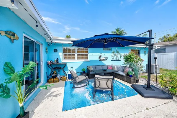 a view of a swimming pool with chairs in patio