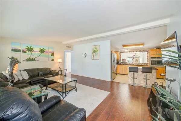 a living room with furniture and a wooden floor