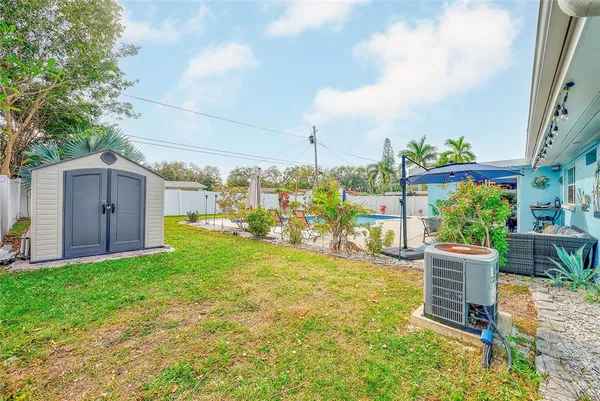 a view of a backyard with plants and a garden