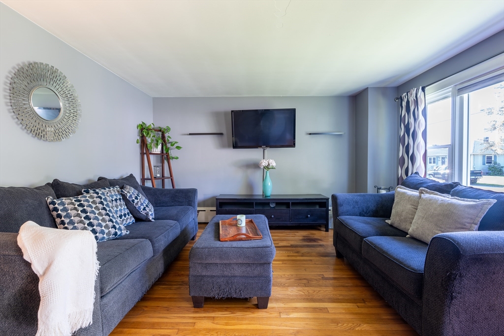 110 James M Beardsworth Road Tiverton, RI 02878 - Photo 5 of 26 a living room with furniture and a flat screen tv