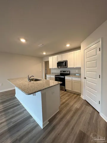 a kitchen with stainless steel appliances granite countertop a stove and a sink