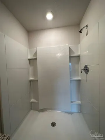 a bathroom with a shower and a toilet
