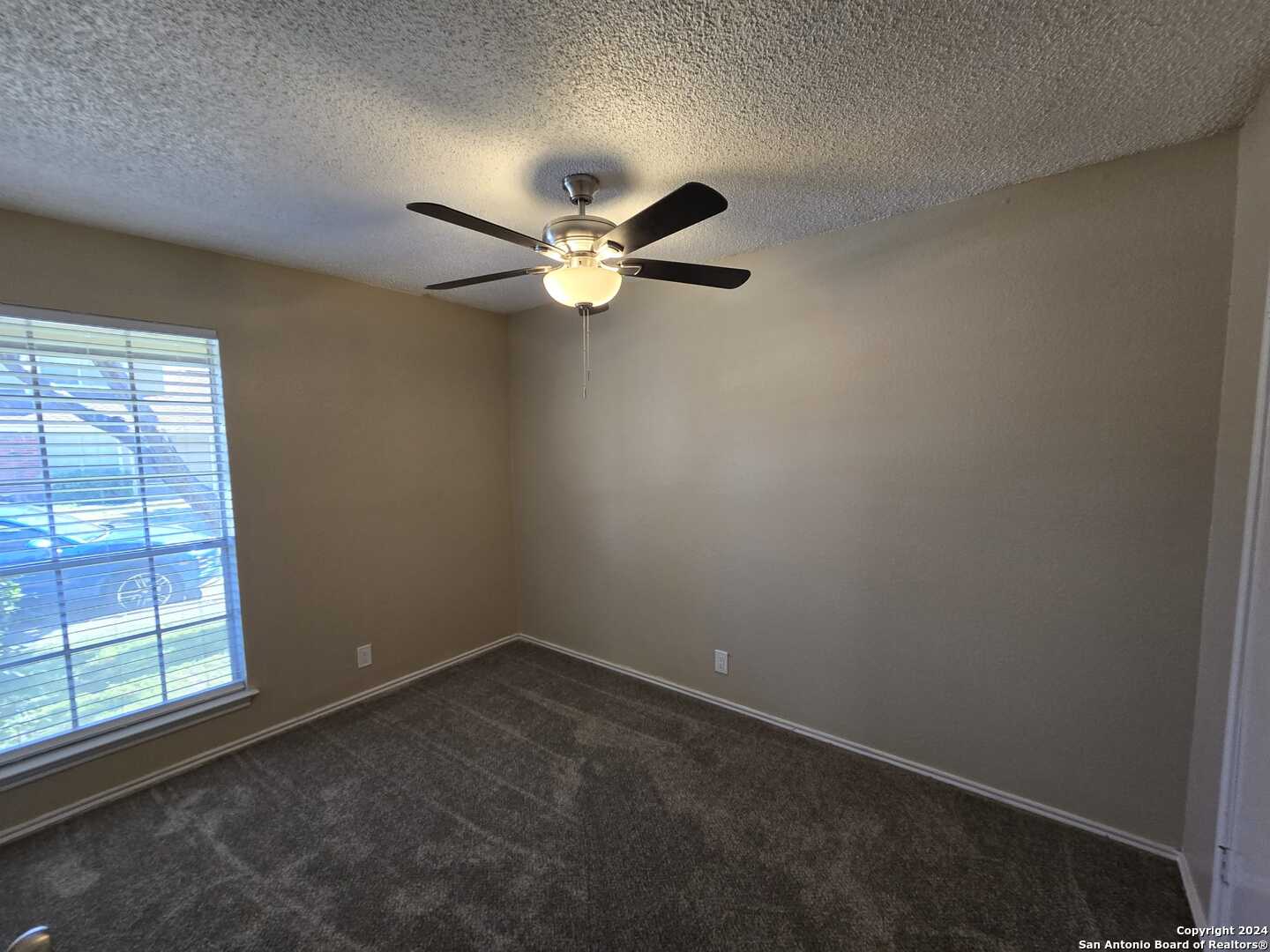9140 Timber Path, Unit 2702 San Antonio, TX 78250 - Photo 14 of 22 an empty room with a window