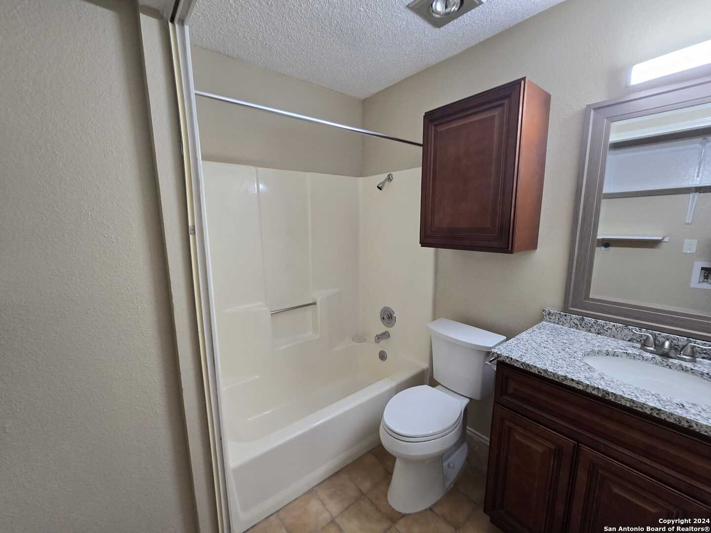9140 Timber Path, Unit 2702 San Antonio, TX 78250 - Photo 16 of 22 a bathroom with a granite countertop sink toilet and shower