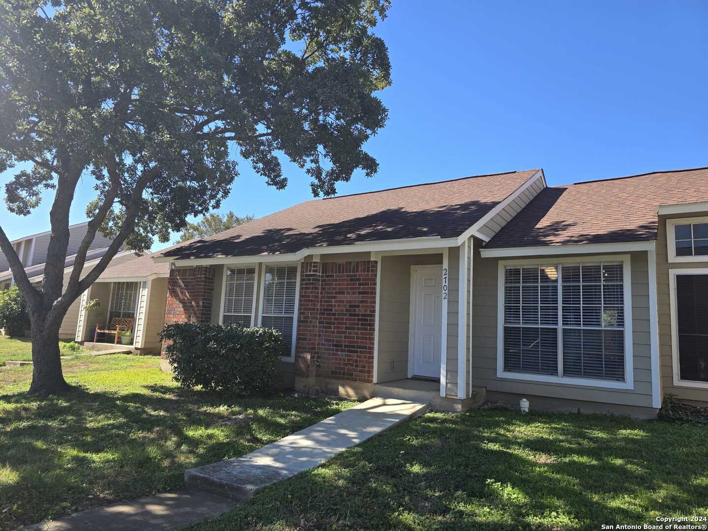 9140 Timber Path, Unit 2702 San Antonio, TX 78250 - Photo 2 of 22 a view of a house with a yard