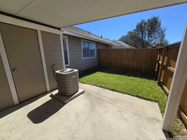 a view of backyard with tub and trees