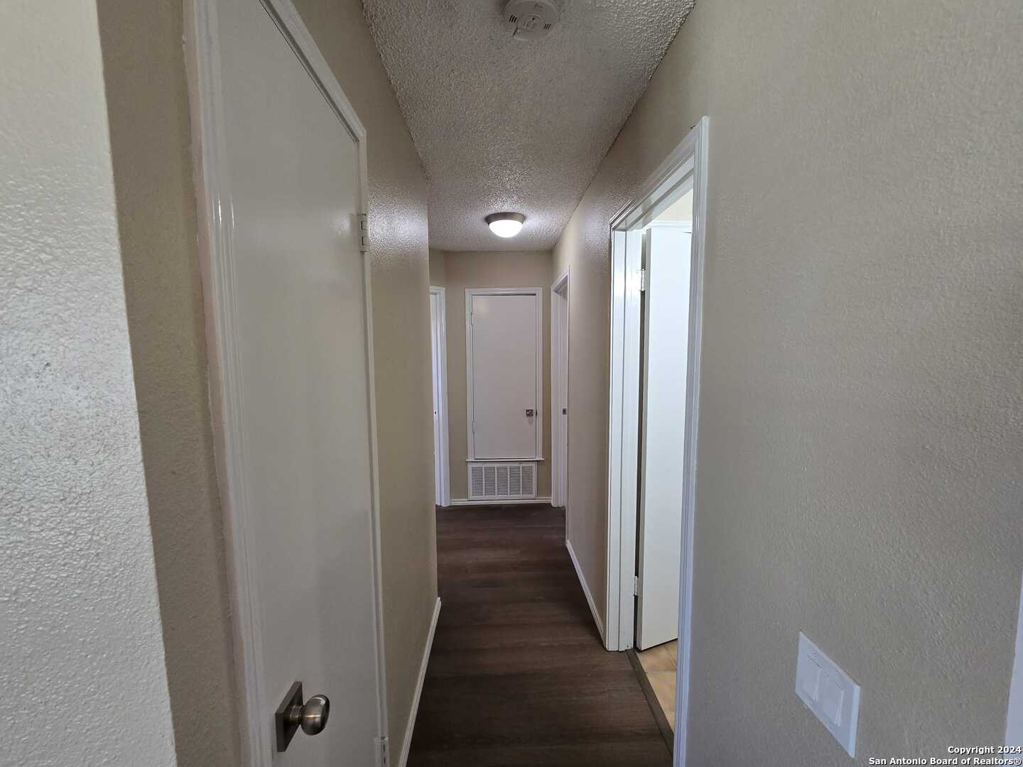 9140 Timber Path, Unit 2702 San Antonio, TX 78250 - Photo 7 of 22 a view of a hallway with wooden floor
