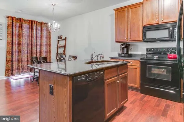 a kitchen with stainless steel appliances granite countertop a sink stove and microwave