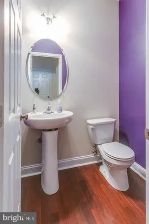 a bathroom with a sink toilet and mirror