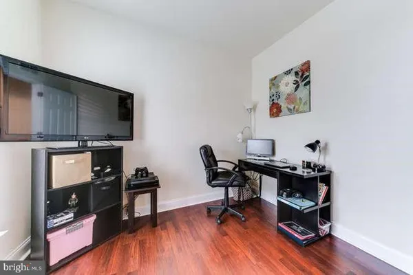 a view of a workspace with furniture and a window