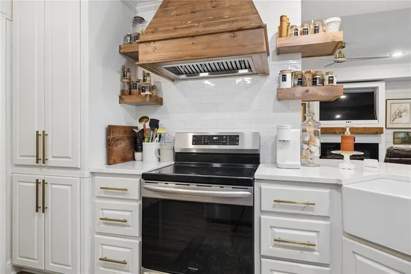 a kitchen with stainless steel appliances granite countertop a stove and a microwave