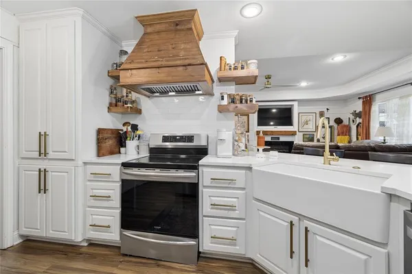 a kitchen with stainless steel appliances a stove sink and cabinets