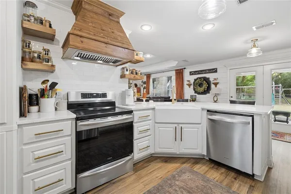 a kitchen with white cabinets and white appliances