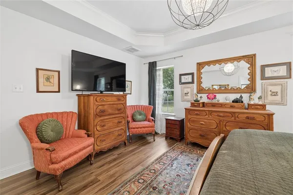 a bedroom with furniture and a flat screen tv