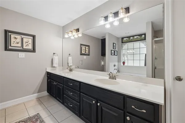 a bathroom with a double vanity sink and a mirror