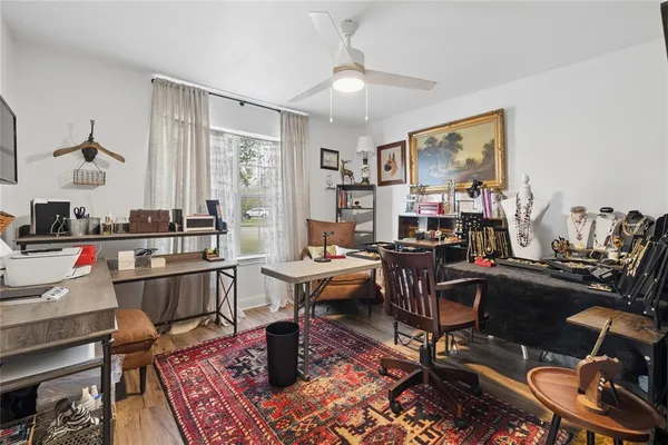 a living room with furniture a piano and a window