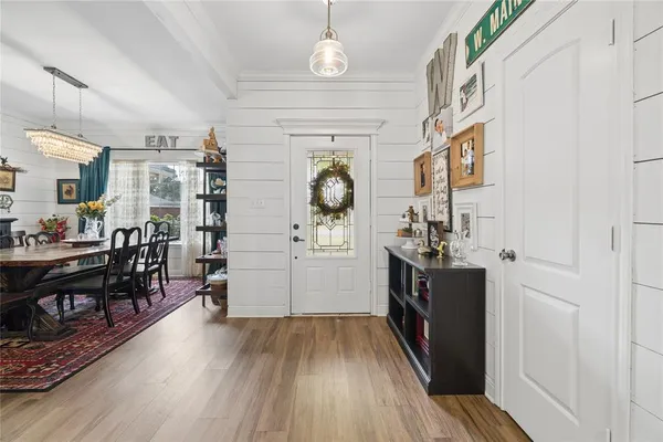 a view of a hallway to dining room and wooden floor