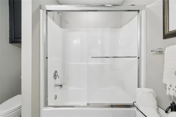 a bathroom with a shower and a bath tub