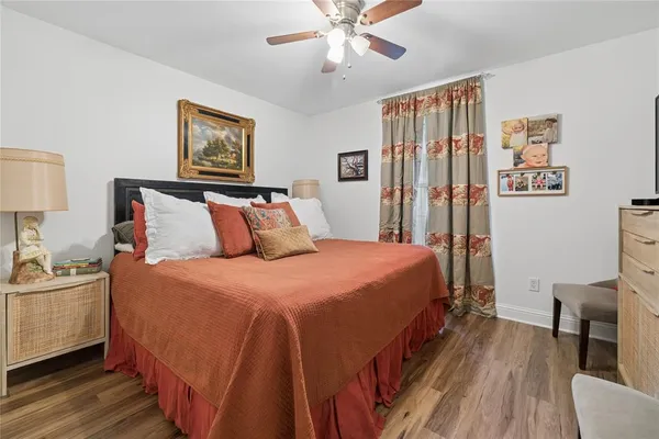 a bedroom with bed and wooden floor