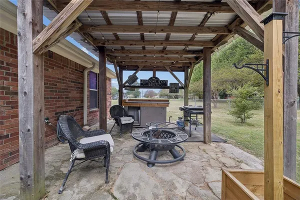 a patio with glass top table and chairs
