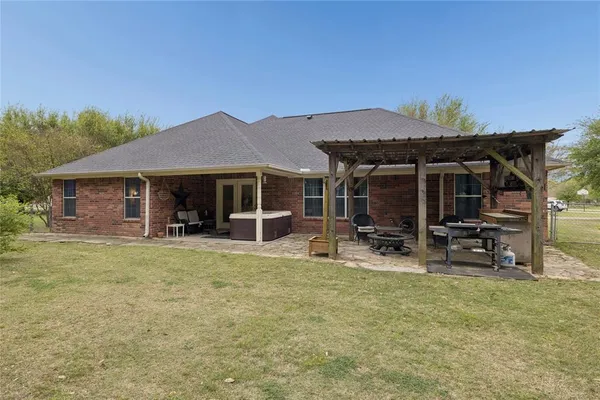 a view of a house with backyard porch and sitting area