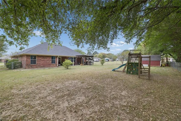 a view of a house with backyard and sitting area
