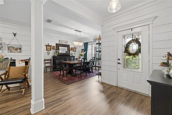 a living room with furniture and wooden floor