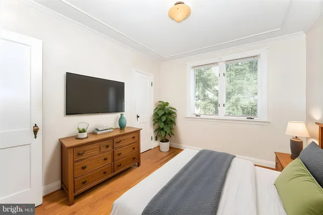 a bedroom with a bed and flat screen tv
