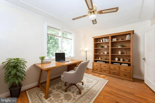 a workspace with furniture window and wooden floor