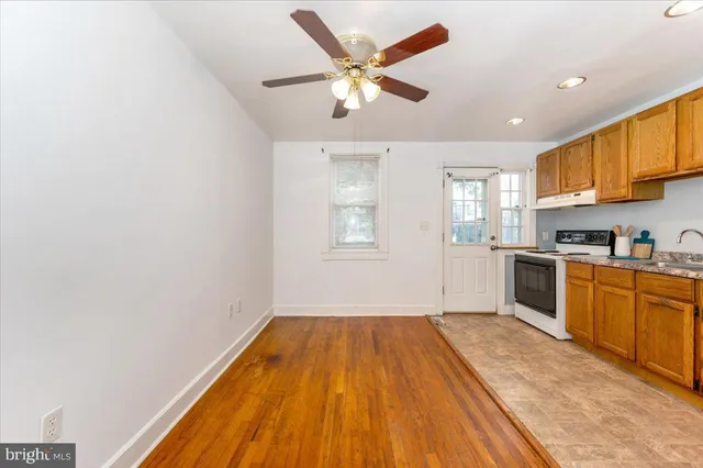 a kitchen with a refrigerator and white cabinets