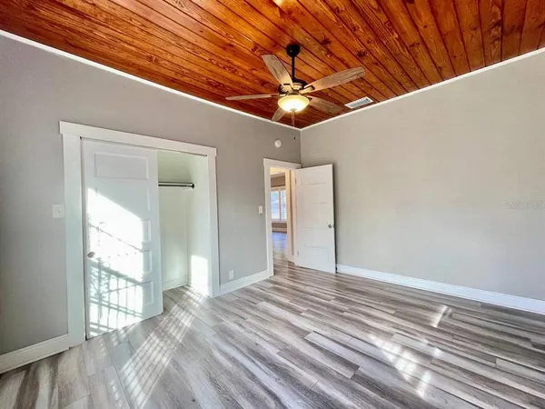 a view of a livingroom with a ceiling fan and window