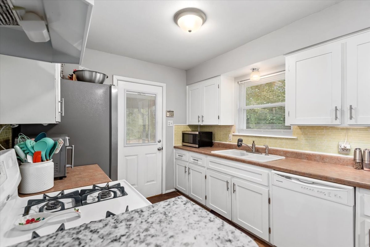 1651 Fultz Court Conroe, TX 77304 - Photo 17 of 38 a kitchen with a sink cabinets and window