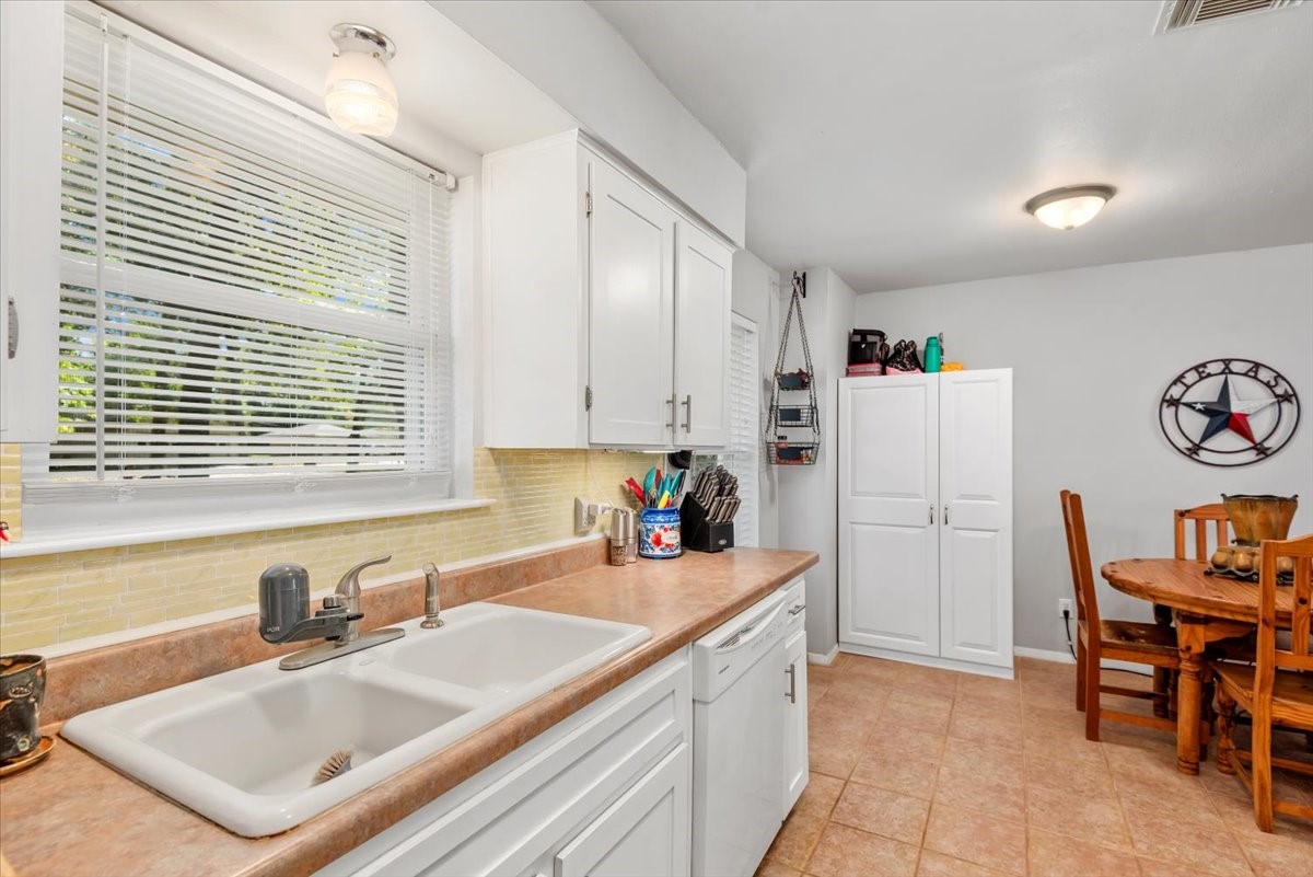 1651 Fultz Court Conroe, TX 77304 - Photo 18 of 38 a kitchen with a refrigerator a sink and a stove