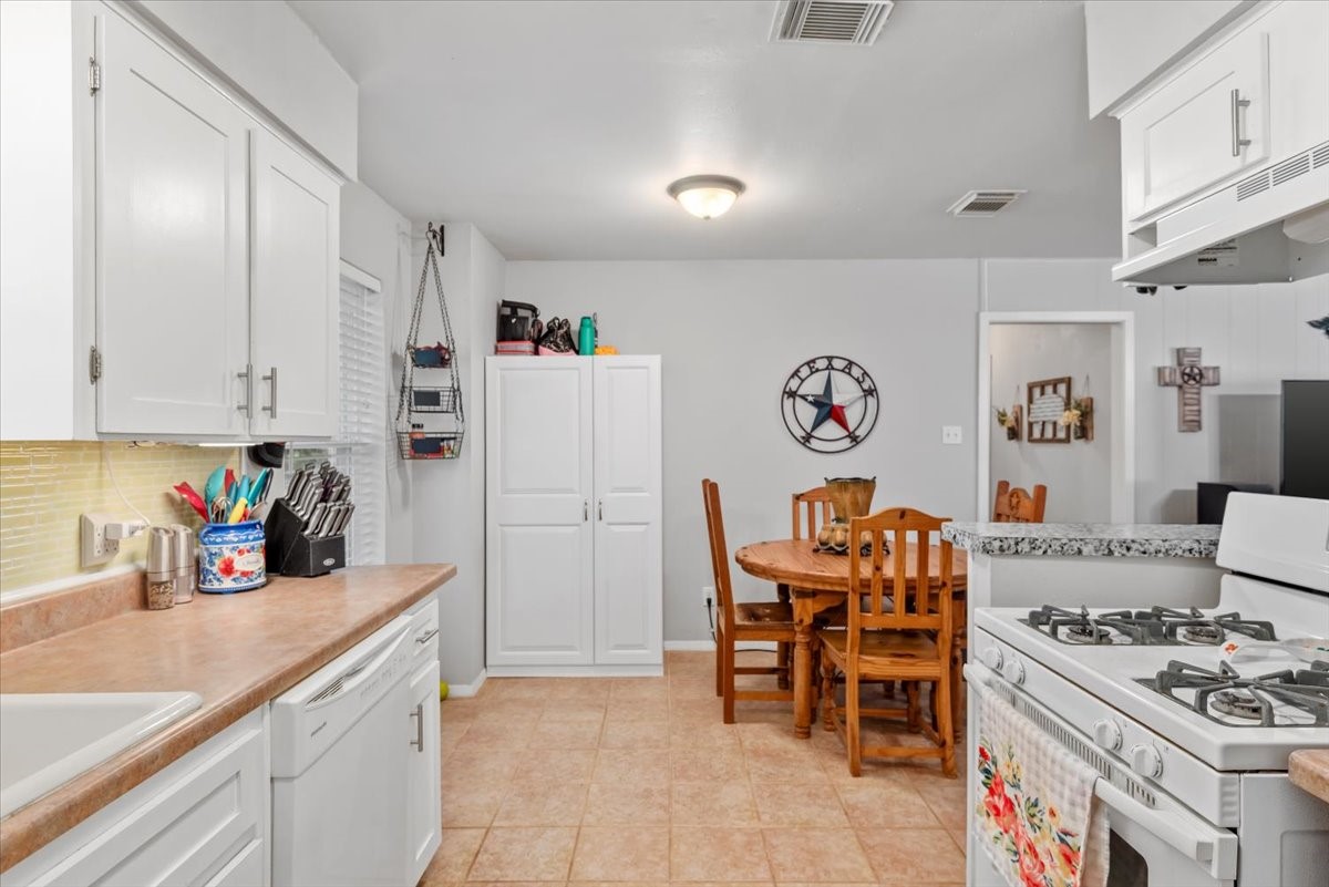 1651 Fultz Court Conroe, TX 77304 - Photo 19 of 38 a kitchen with stainless steel appliances granite countertop a refrigerator and a sink